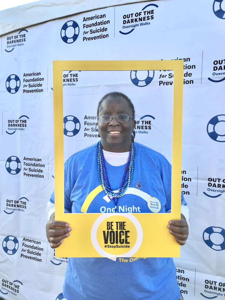 Catharyn Turner posing with a "Be The Voice" photo frame at an Out of The Darkness walk