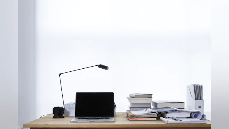 A desk with books on top