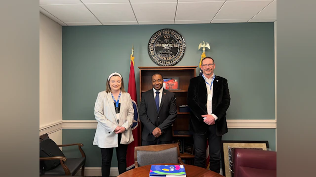 Two advocates pose with a state legislator.