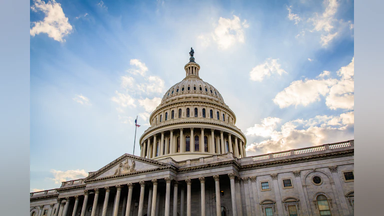 Photo of the US capitol building with blue sky in the background