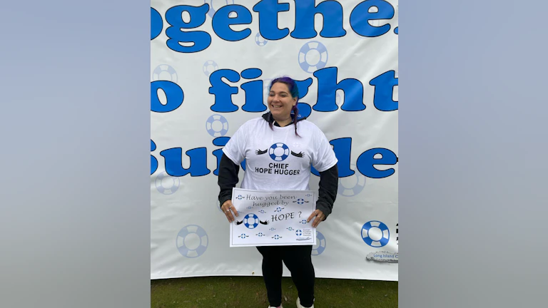 New York Long Island Chapter volunteer Jaclyn Haber smiling with a white t-shirt that says, "Chief Hope Hugger."