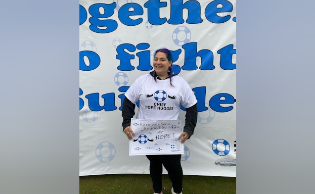 New York Long Island Chapter volunteer Jaclyn Haber smiling with a white t-shirt that says, "Chief Hope Hugger."