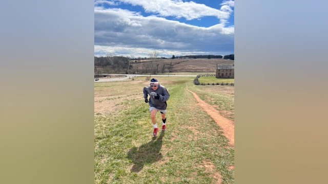 Raymond Burke running up a grassy hill to train for AFSP's Out of the Darkness Overnight Walk.