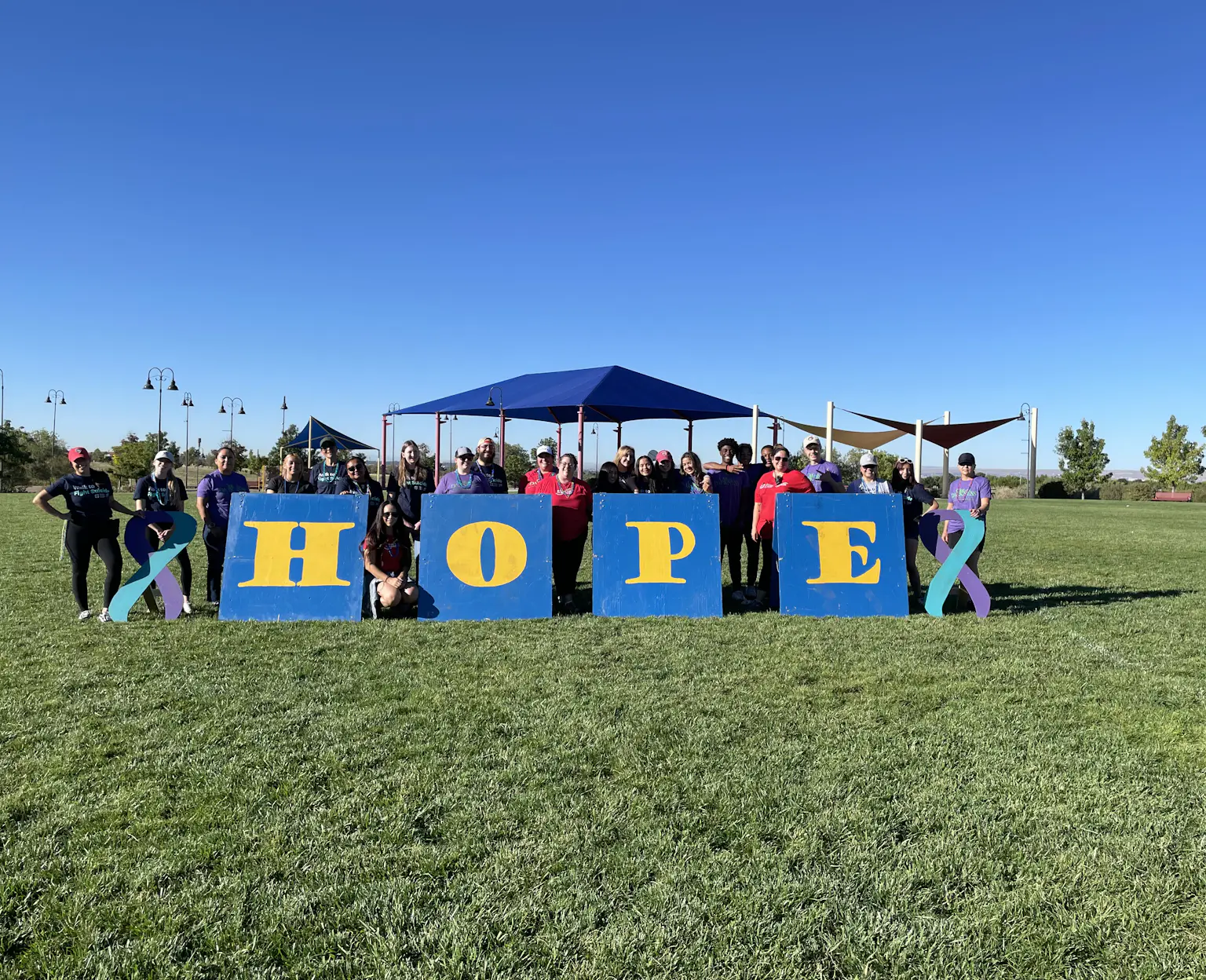 Volunteers at Albuquerque walk posing with HOPE sign.