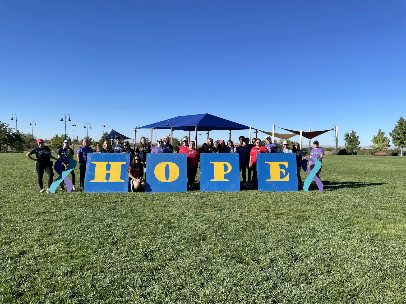 Volunteers at Albuquerque walk posing with HOPE sign.