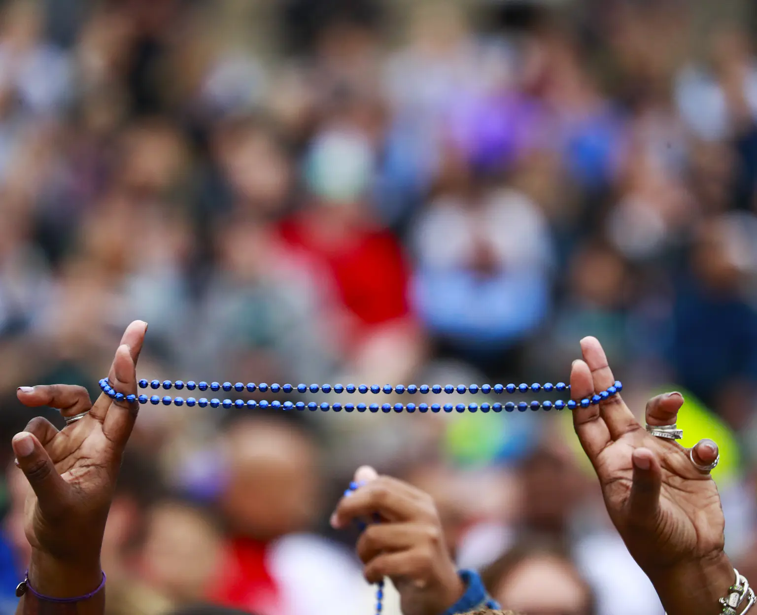 Hands holding honor beads