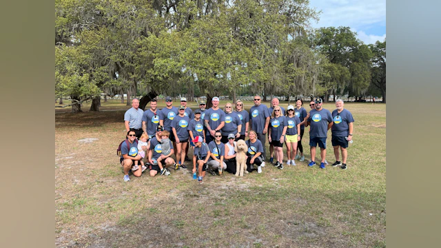 Group of people gathered outside in matching t-shirts at the Construction Hike for Hope.