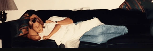 Young Jessica Molberg on the couch with her dad.