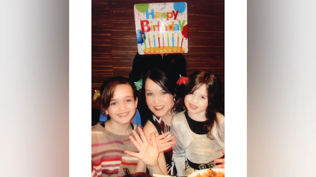 Young Taylor Ryan with her mother, Sabrina Jones, and a "Happy Birthday!" sign in the background.