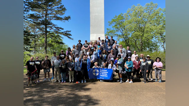 A group of people pose for a photo outdoors