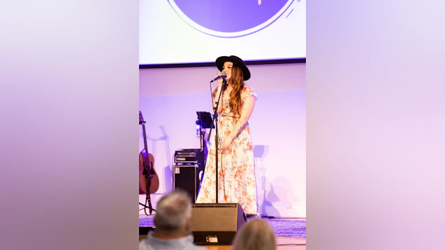 A woman is singing on stage