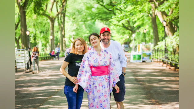 Masako, Naomi, and Ethan Sacks standing together outside for a family photo. By Takako Harkness