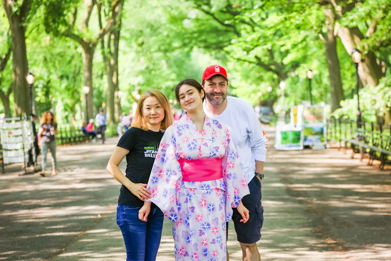 Masako, Naomi, and Ethan Sacks standing together outside for a family photo. By Takako Harkness