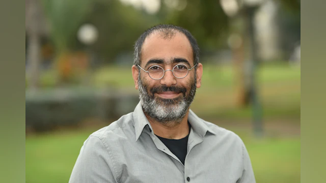 A headshot of the author, Yossi Levi-Belz, PhD, standing outside and smiling.