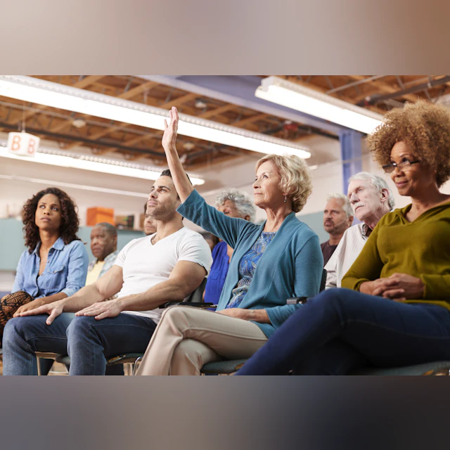 Woman raising her hand during a presentation