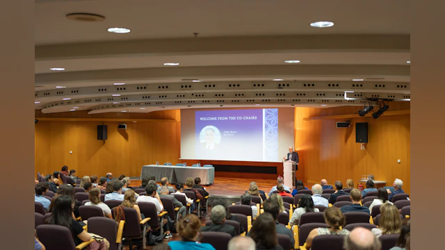 Attendees in auditorium seats at opening of the International Summit on Suicide Research