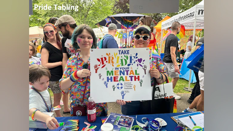 Volunteers tabling at Pride Month event