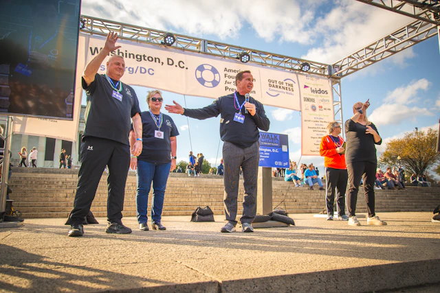 President and CEO of Pepco Holdings Tyler Anthony joined by President of the International Brotherhood of Electrical Workers Local 1900 Jerry Williford and Pepco Holdings’ Vice President Support Services Sandy Fisher during the 2023 Washington, D.C. Out of the Darkness Community Walk's Opening Ceremony