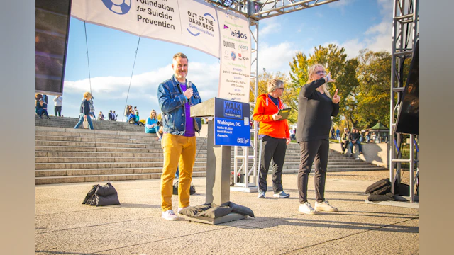 Leidos’ Director of ESG and Corporate Responsibility Daniel Pellegrom speaking on the steps of the Lincoln Memorial at the 2023 Washington, D.C. Out of the Darkness Community Walk