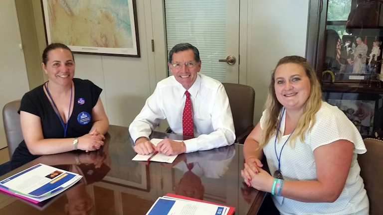 The author Donna Birkholz, left, with Senator John Barrasso of Wyoming, middle.