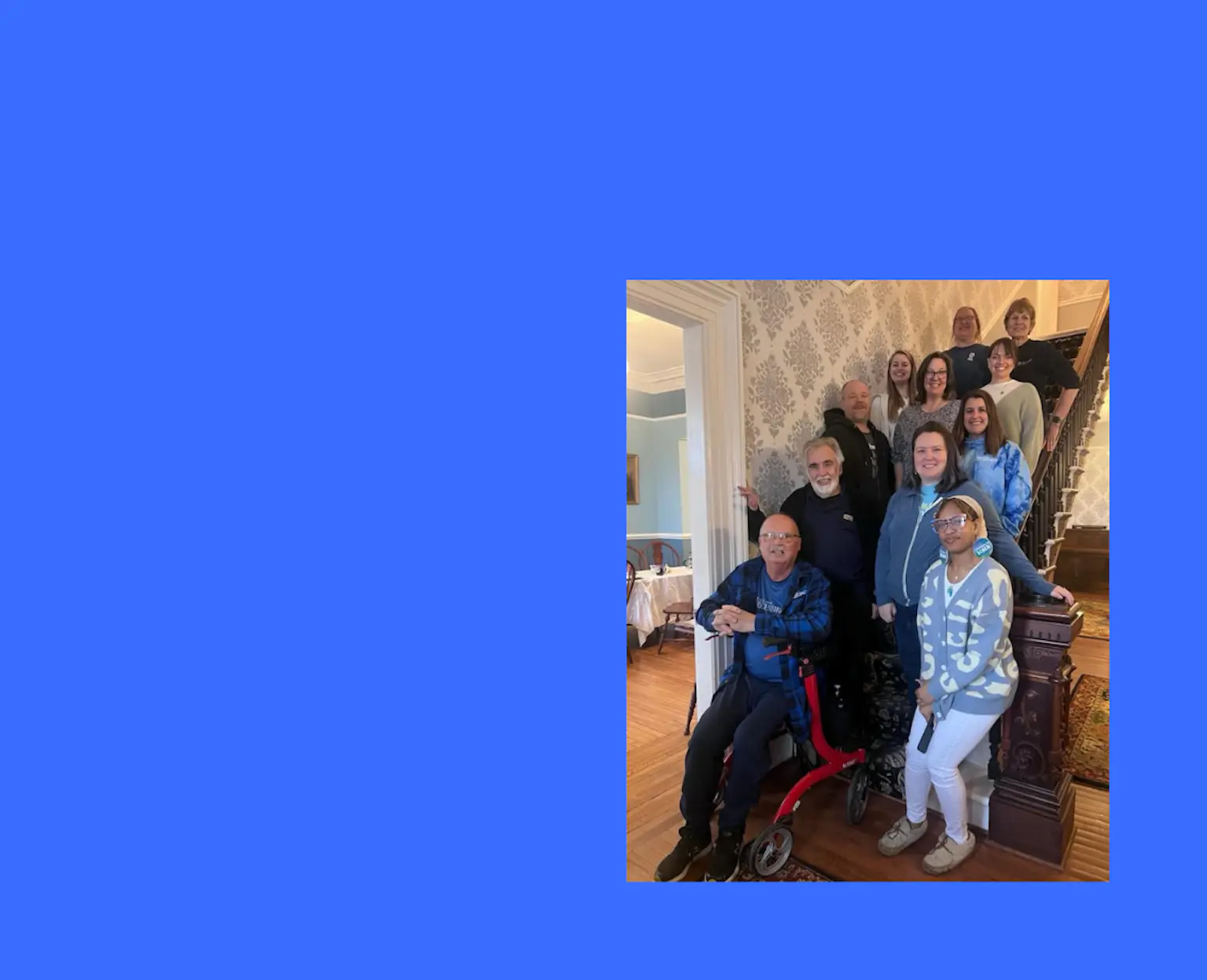 11 people standing on stairs for group photo