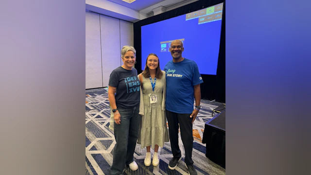 3 people smiling and posing for the camera