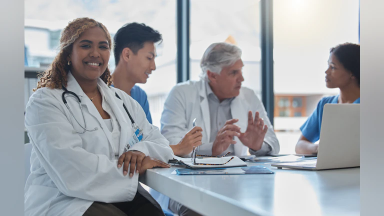 Clinicians sitting at a table.
