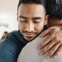 Man hugging another person