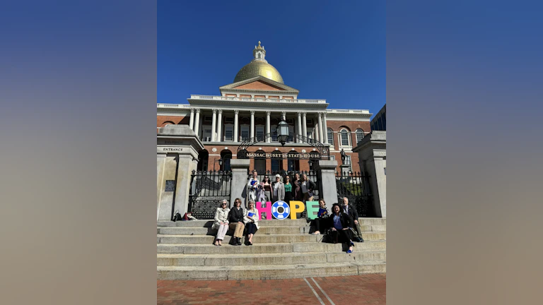 Advocactes in front of the Massachusetts state capitol