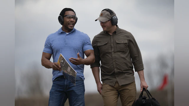 Two men discussing firearms safety