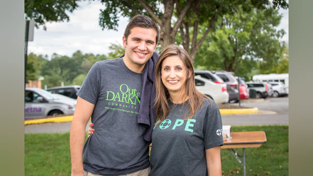 The author, Ali Walker, standing outside at an Out of the Darkness Walk event and wearing an AFSP "HOPE" t-shirt.