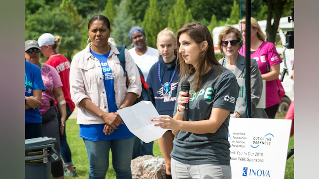 Ali delivering a speech at an Out of the Darkness Walk event.
