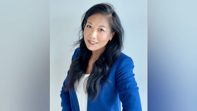 Karen Ng smiling for a headshot and wearing a cobalt blue blazer.