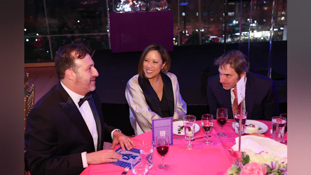 Ethan Sacks and Cindy Hsu talking at their table the evening of the Lifesavers Gala.