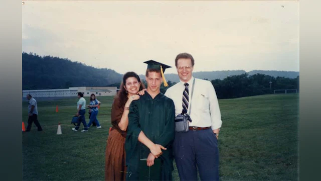 Dan Egan at his high school graduation, standing next to his dad.