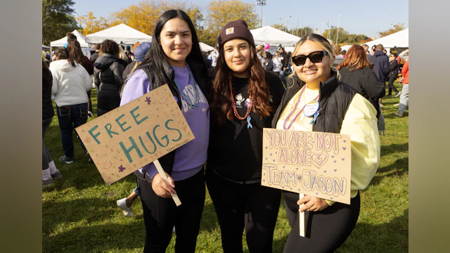 Three women holding inspirational signs.