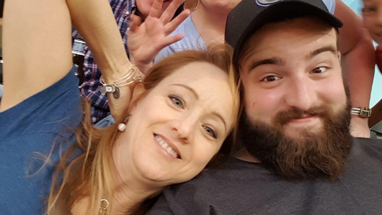 The author, Mary Kerby, with her son Adam. The two are sitting next to each other with big smiles.