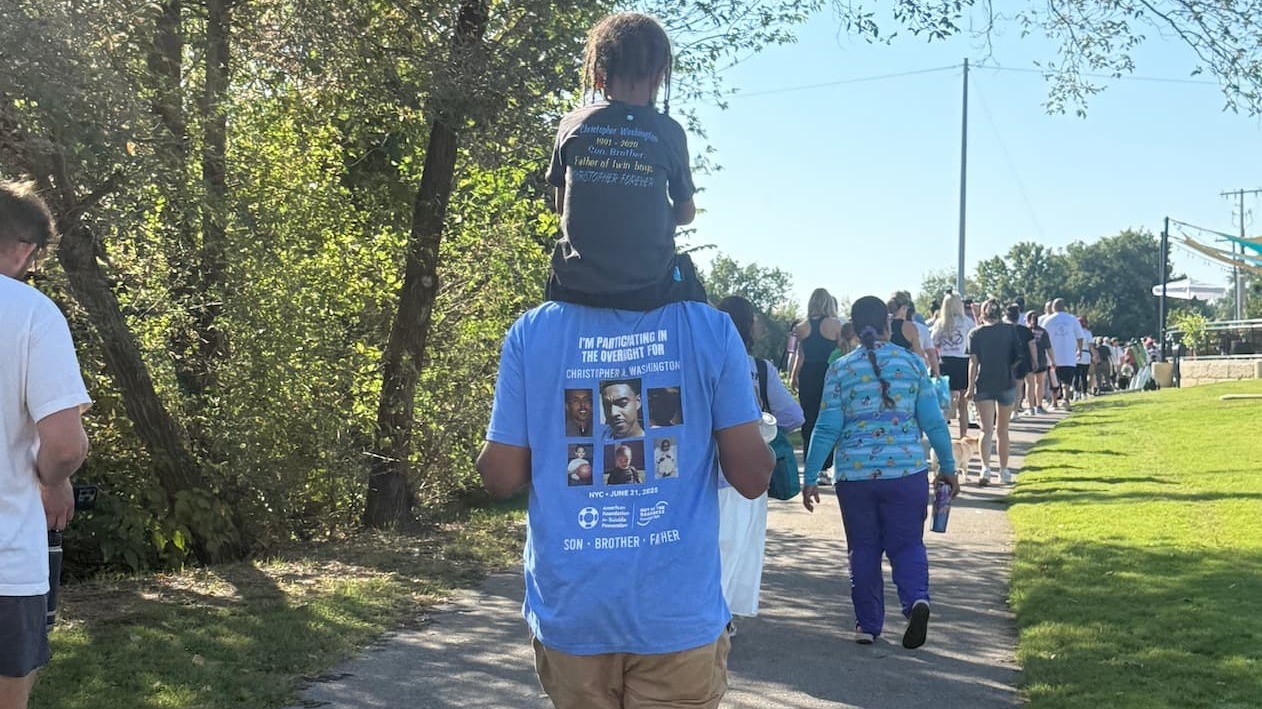 Bill Washington at an Out of the Darkness Walk, wearing a t-shirt with his son's name and pictures on it.