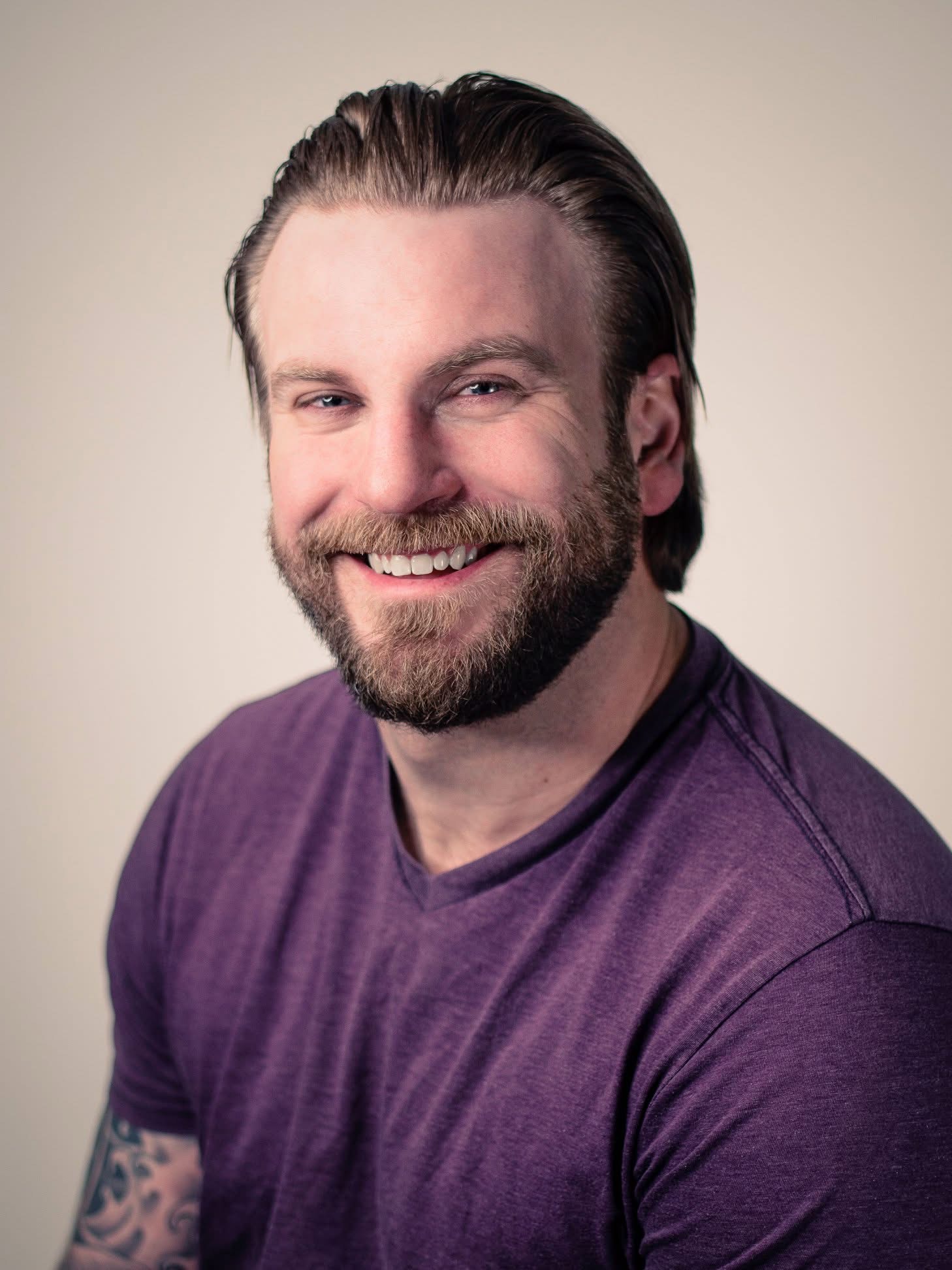 The author, Jared Porter, wearing a purple t-shirt and smiling for a photo.