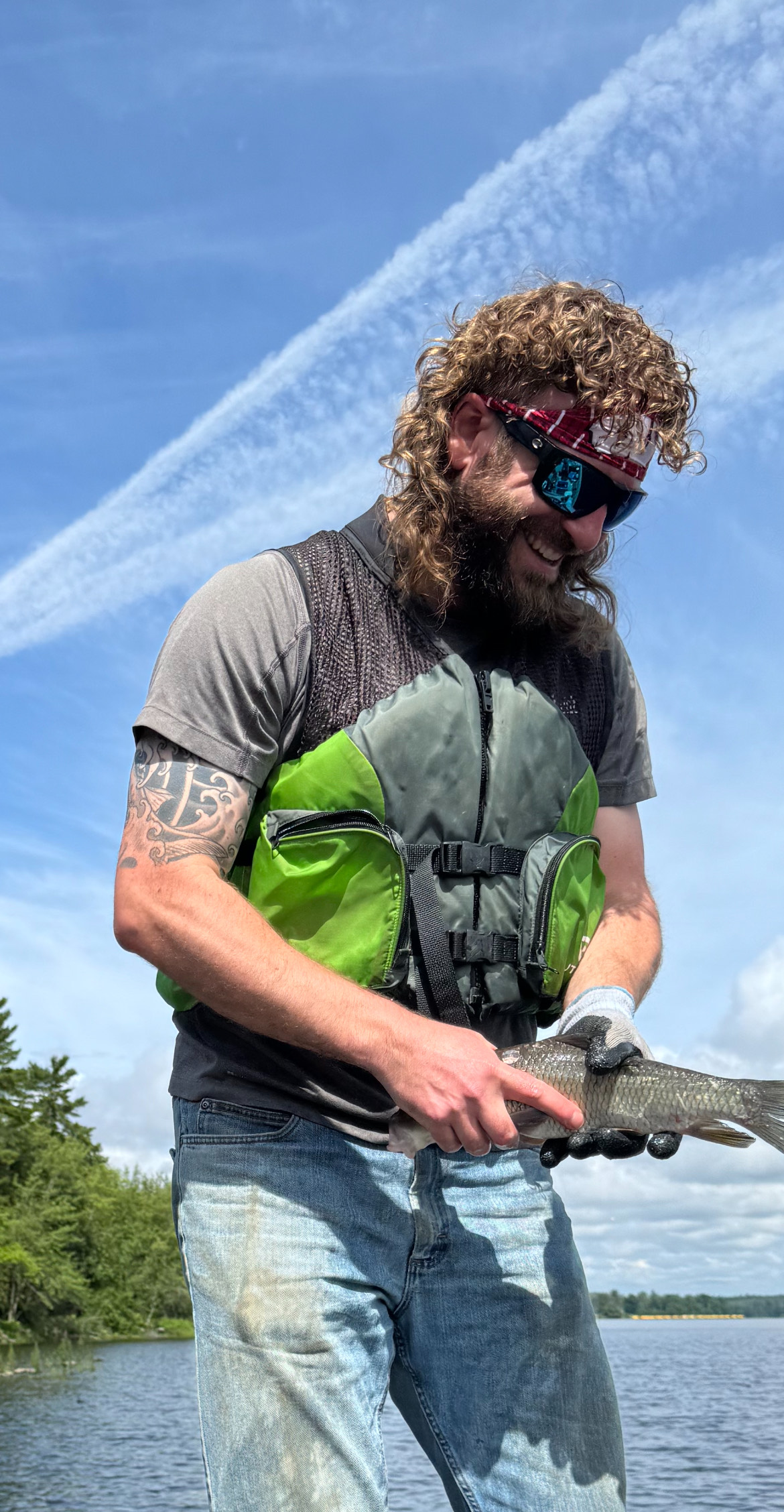 A picture of the author, Jared Porter, smiling while holding a fish he caught.