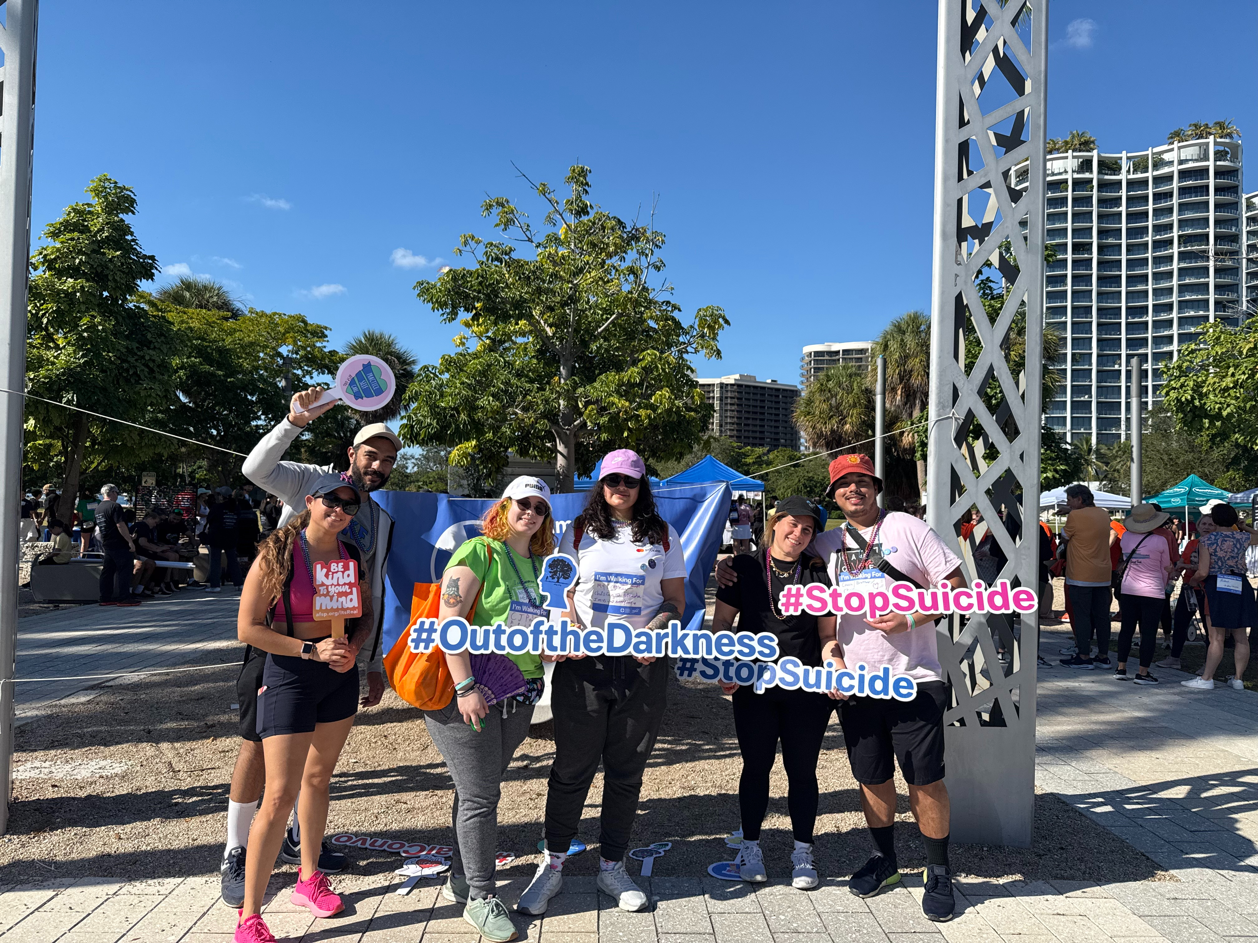 Group of people holding lettered signs