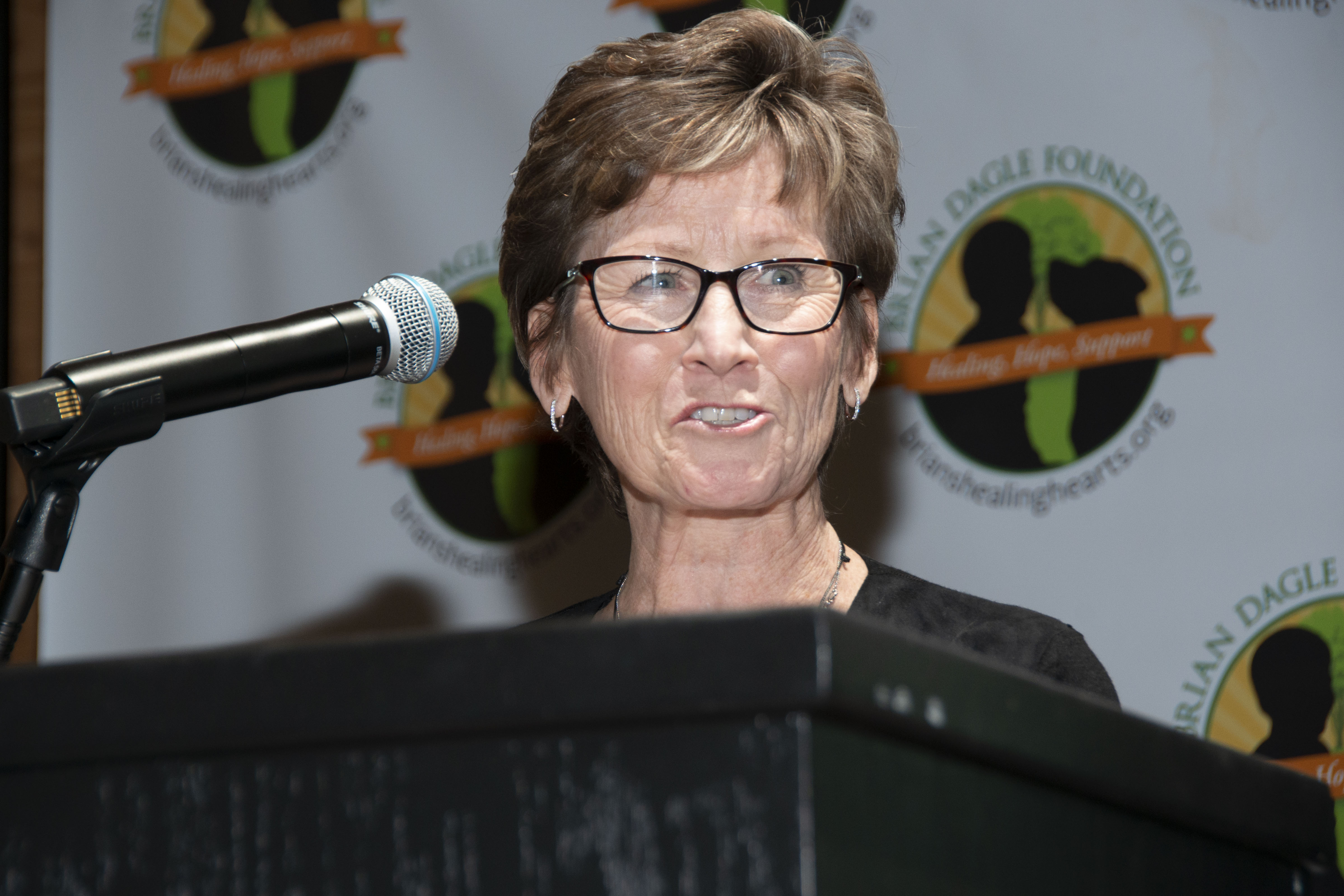 The author, Ann Dagle, standing at a podium at an event.