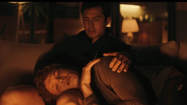 Still of Shane and Ilya sharing an intimate, emotional moment by the fire pit at Shane's cottage.