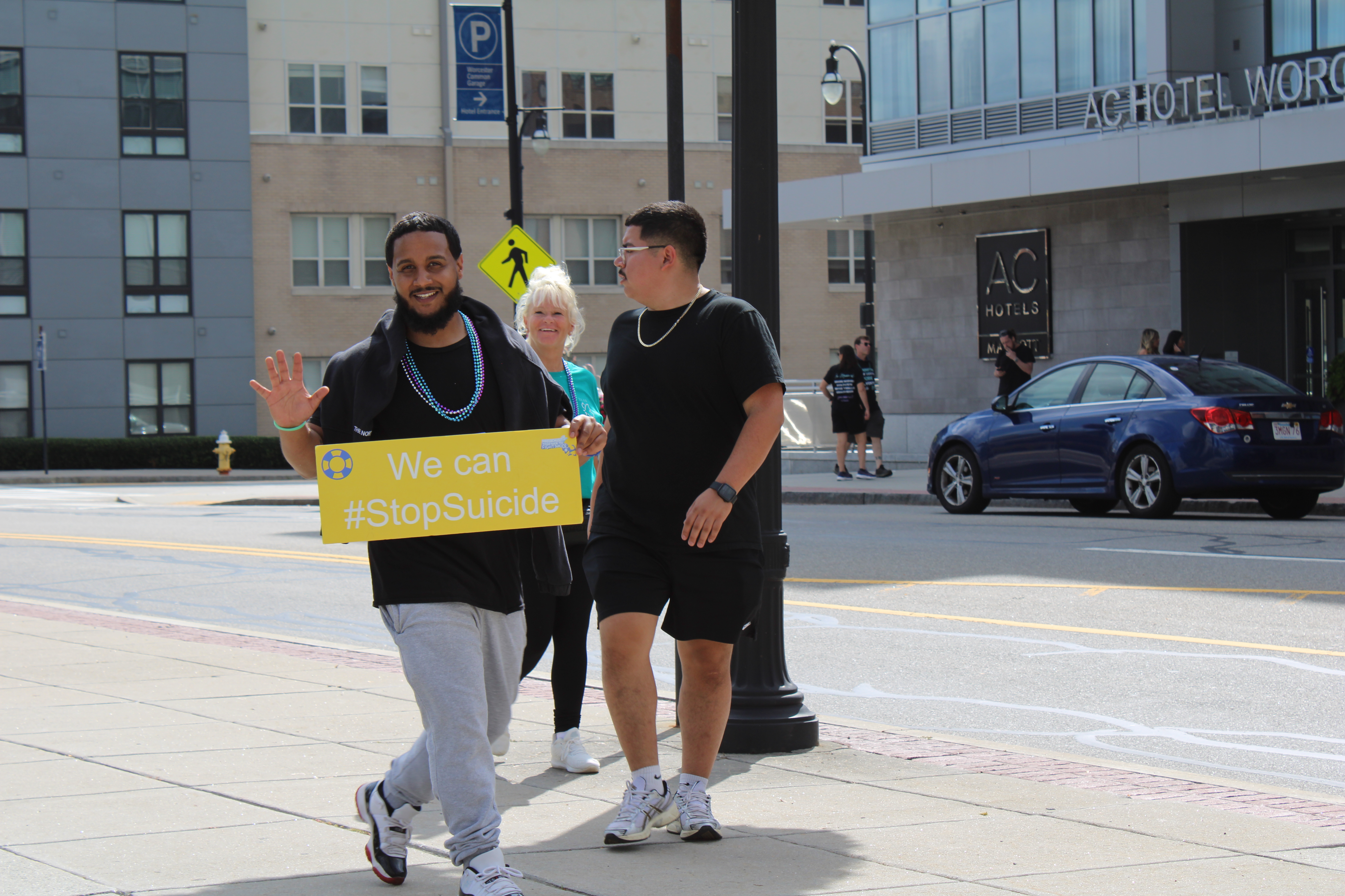Man holding We Can #StopSuicide sign