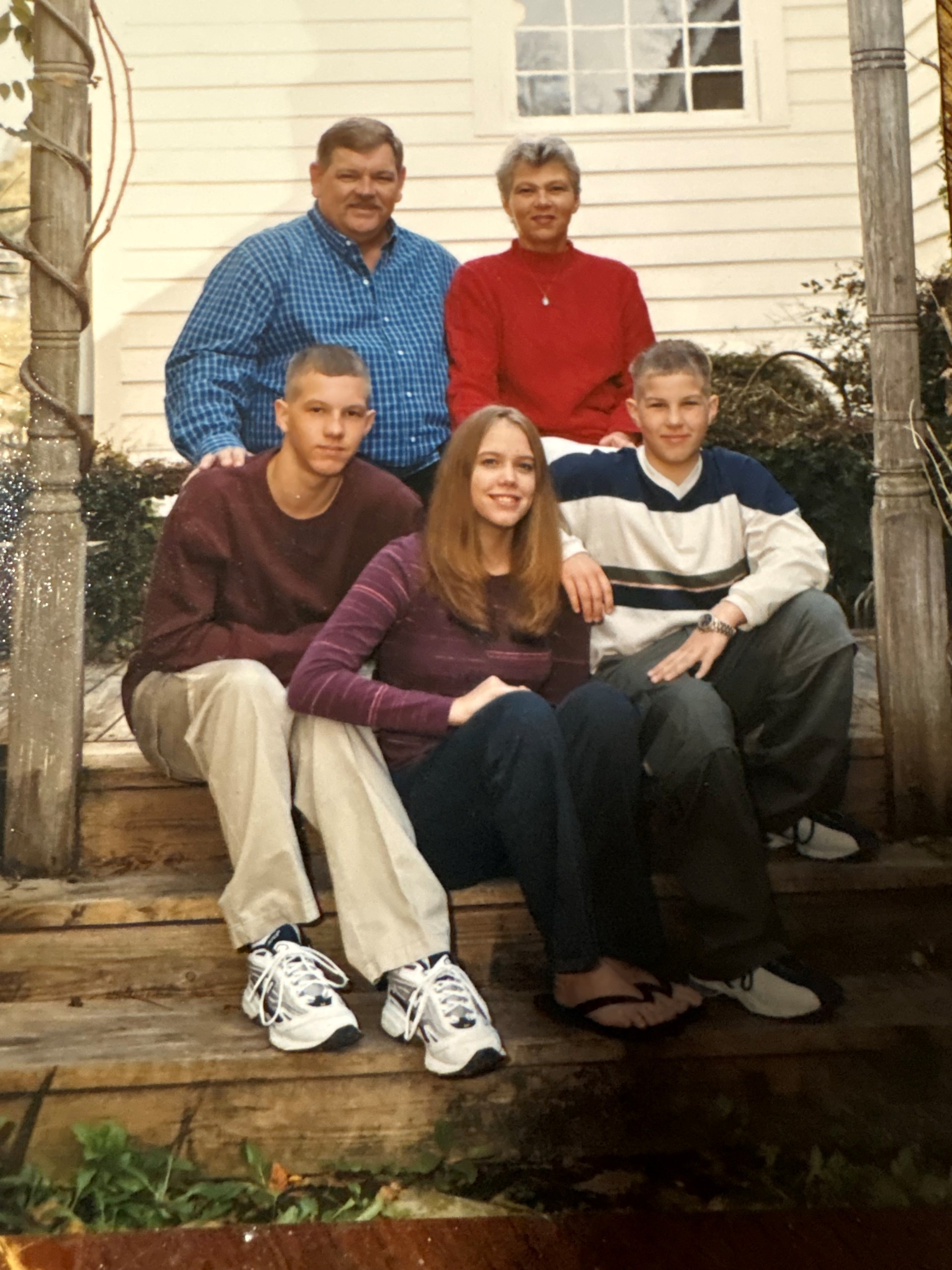 Bubba Randall posing with his wife and three children, including Jessie, for a family photo.