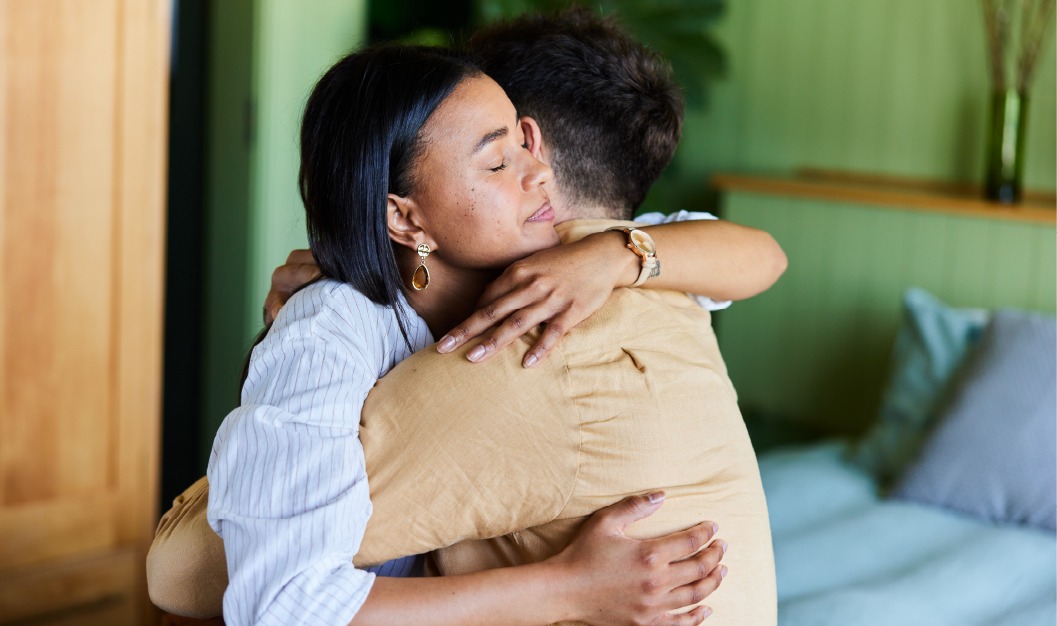 Two individuals hugging in a calming space
