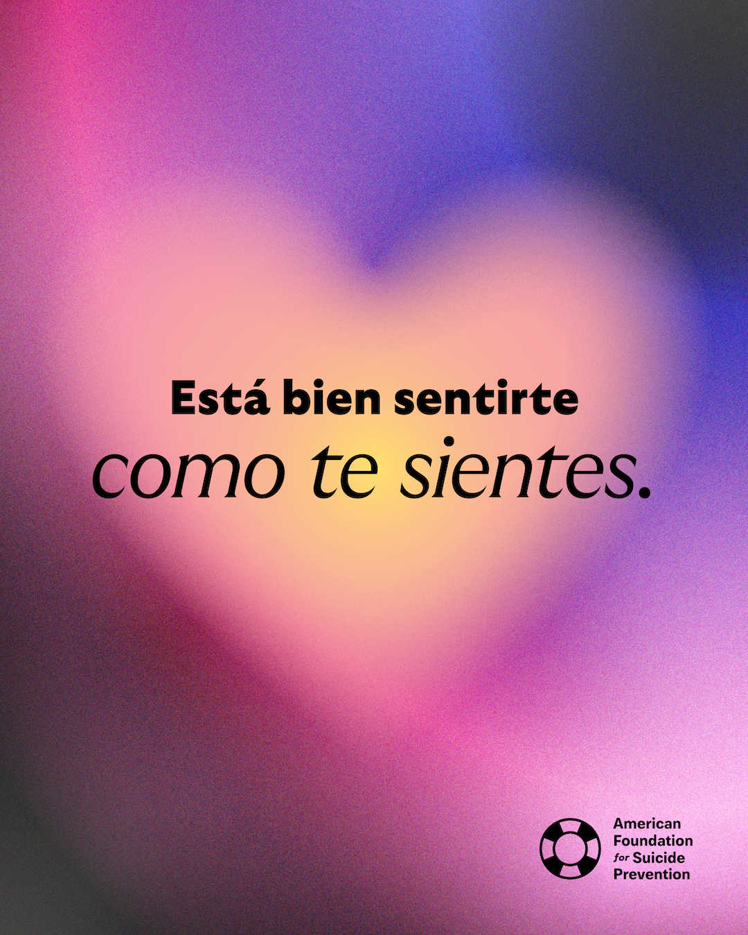 Spanish-language graphic reading “Está bien sentirte como te sientes” (You are allowed to feel however you feel). Black lettering over a blurred pink and yellow heart-shaped glow, with the American Foundation for Suicide Prevention logo.