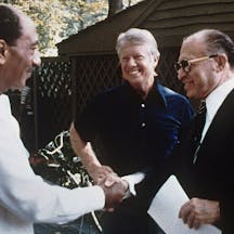 Israeli prime minister Menachem Begin and Egyptian president Anwar Sadat with U.S. president Jimmy Carter at Camp David in September 1978. *U.S. Government Archives via Wikimedia.* 1280px-Camp_David,_Menachem_Begin,_Anwar_Sadat,_1978