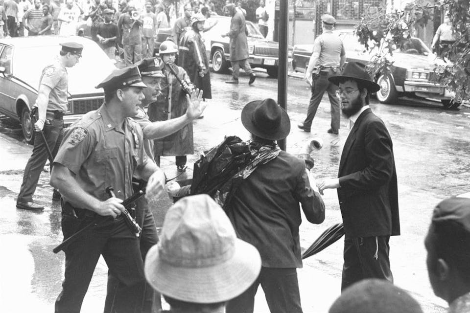 On August 20, 1991, police officers try to calm two Orthodox Jews during a confrontation with black residents of Crown Heights in Brooklyn, New York. *Photo by NY Daily News Archive via Getty Images.* Kaufman-Main