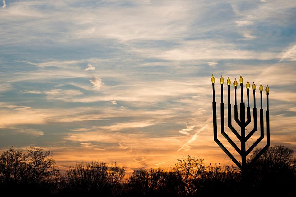 The National Menorah, in Washington, DC on December 10, 2015. *Andrew Caballero-Reynolds/AFP via Getty Images*. The National Menorah, part of the Jewish holiday of Hanukkah, is silhouetted against the setting sun in Washington, DC on December 10, 2015.
The holiday commemorates the re-dedication of the holy temple in Jerusalem after the Jews’ 165 B.C. victory over the Hellenist Syrians when Antiochus, the Greek King of Syria, outlawed Jewish rituals and ordered the Jews to worship Greek gods. / AFP / Andrew Caballero-Reynolds (Photo credit should read ANDREW CABALLERO-REYNOLDS/AFP via Getty Images)